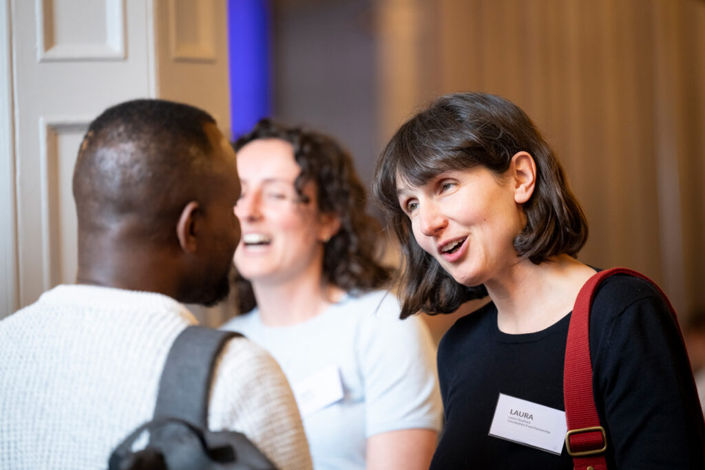 image shows a woman talking to a man at the big tent event 2024